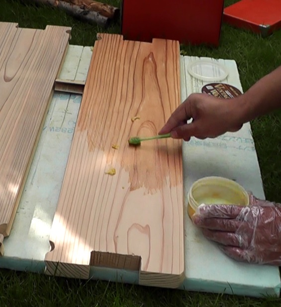 サンダーでの磨きが完了した木材に歯ブラシを使用してワックス（オイル）を塗布降る